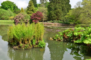 Fototapeta na wymiar An English country garden with a lake in late springtime.