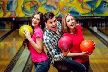 Fototapeta na wymiar Cheerful friends at the bowling alley