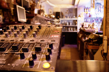 Music control center or deck in a retail store with sound, amplifier and mixing knobs for broadcasting to entertain customers