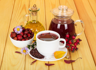 Drink for immunity from  hips and grasses on  light wood.