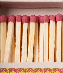 Matches against the backdrop  an open box closeup.