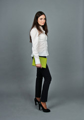 Woman in white blouse standing and keep her green notes