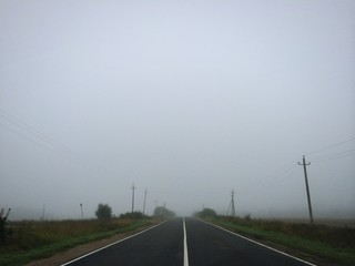 Fototapeta premium Empty foggy asphalt road