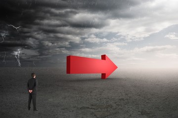 Composition image of a businessman looking an arrow 