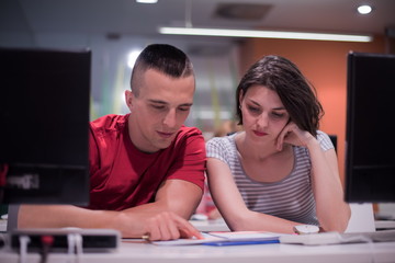 technology students group working  in computer lab school  class