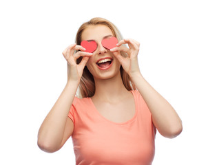 happy young woman with red heart shapes on eyes