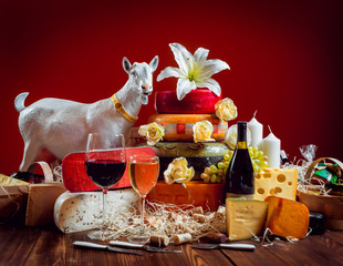 Cheese and wine on a dark table.