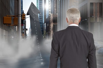 Fototapeta premium Composition image of a businessman looking an arrow 