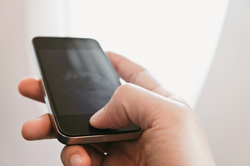 close up of business man siting near airplane window and watching his phone, Business communication