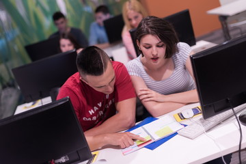 technology students group working  in computer lab school  class