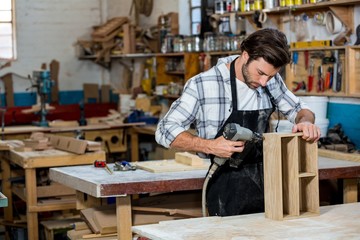 Carpenter working on his craft in a dusty workshop