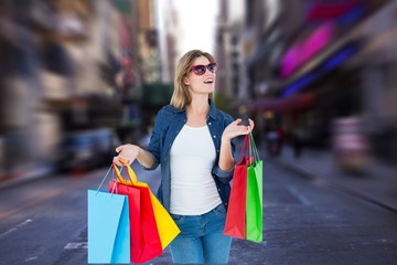 Composite image of smiling woman going shopping