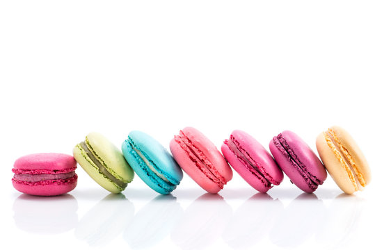Colorful macarons line isolated on white background