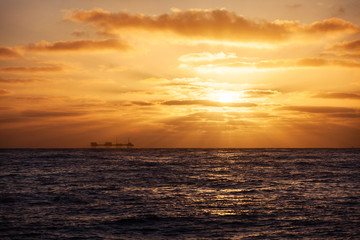 Oil platform in USA at sunset