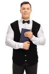Young waiter holding a menu