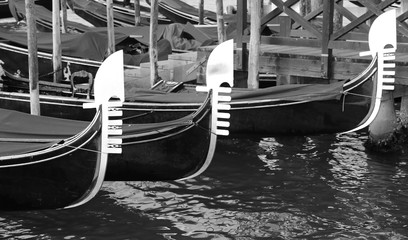 Fototapeta na wymiar three prows of Venetian gondolas