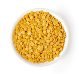 Bowl of yellow lentils isolated on white, from above