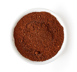 Bowl of coffee powder isolated on white, from above