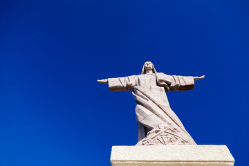the statue of Jesus Christ with a blue sky background
