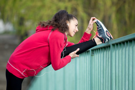 Runner Woman Doing Hamstring Stretch After Jogging