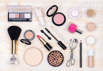 Makeup cosmetics on white, wooden background, top view