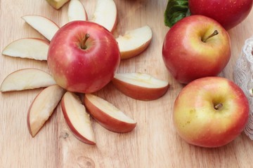 red apples is delicious on wood background.