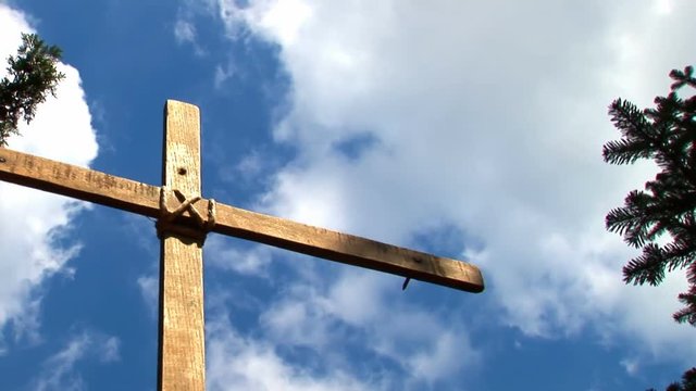 Wooden cross against blue sky
