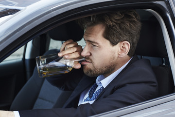 Drunken businessman driving, side view