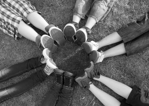 Teenage Boys And Girls Feet And Legs Touching In Circle