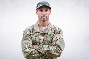Composite image of an american soldier posing and crossed arms