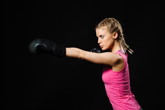 Beautiful determined woman with boxing gloves. 