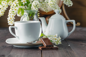 Cup of tea and cherry on wooden background