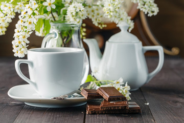 Cup of tea and cherry on wooden background