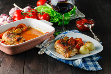 Baked chicken wings with vegetables on plate