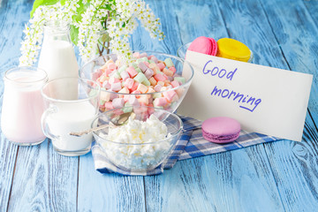 Glass of milk with Tasty macaroon on with background