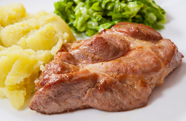 meat fillet steak with mashed potatoes and vegetables salad in a plate