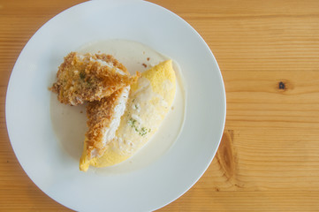 Flat lay of Omurice / Omelette rice with fish fried / Fried rice