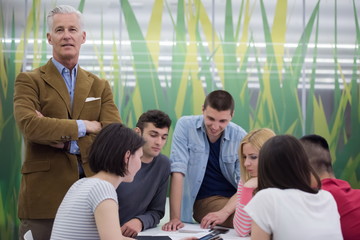 portrait of  teacher with students group in background