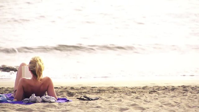 A blonde woman in the beach. Relax.