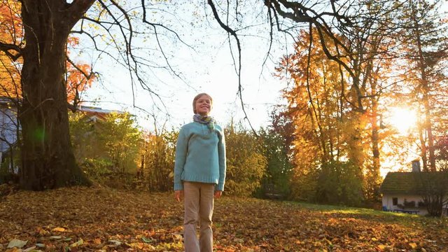 Boy Tossing Leaves