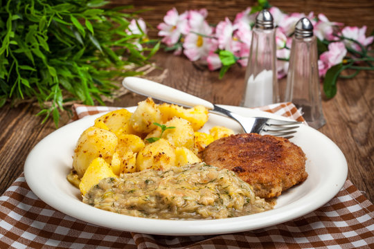 Delicious meal of minced meat cutlet, potatoes and fried cabbage