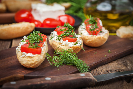 Delicious bruschetta with tomatoes, feta cheese, dill and spice