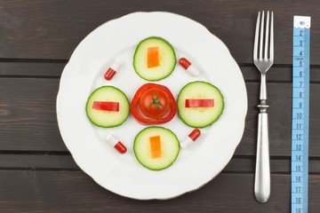 diet and supplements on a wooden table. Strict diet meals. Slimming diet. Tomatoes and pills.
