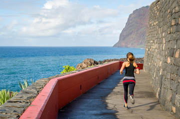 Sporty woman running seaside