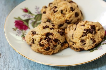 Homemade Chocolate chip cookies served in a beautiful floral plate, selective focus