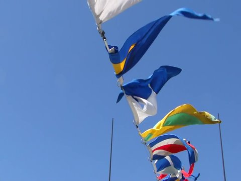 Signal flags flying against blue sky 	 on the Coast Guard cutter USCGC Alert 	in Seattle
