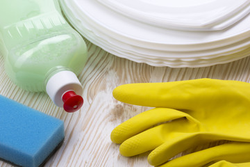 Detergent,sponge, dishes and latex gloves