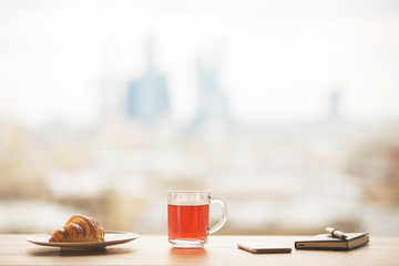 Table with tea and croissant