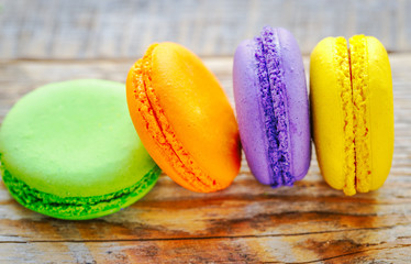 pile of multicolored macaroon cookies on a wooden table