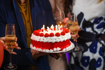 Happy birthday! Group people holding cake.